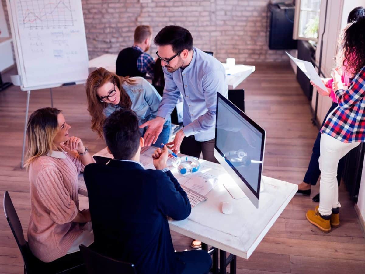 picture-of-young-realtors-discussing-in-office